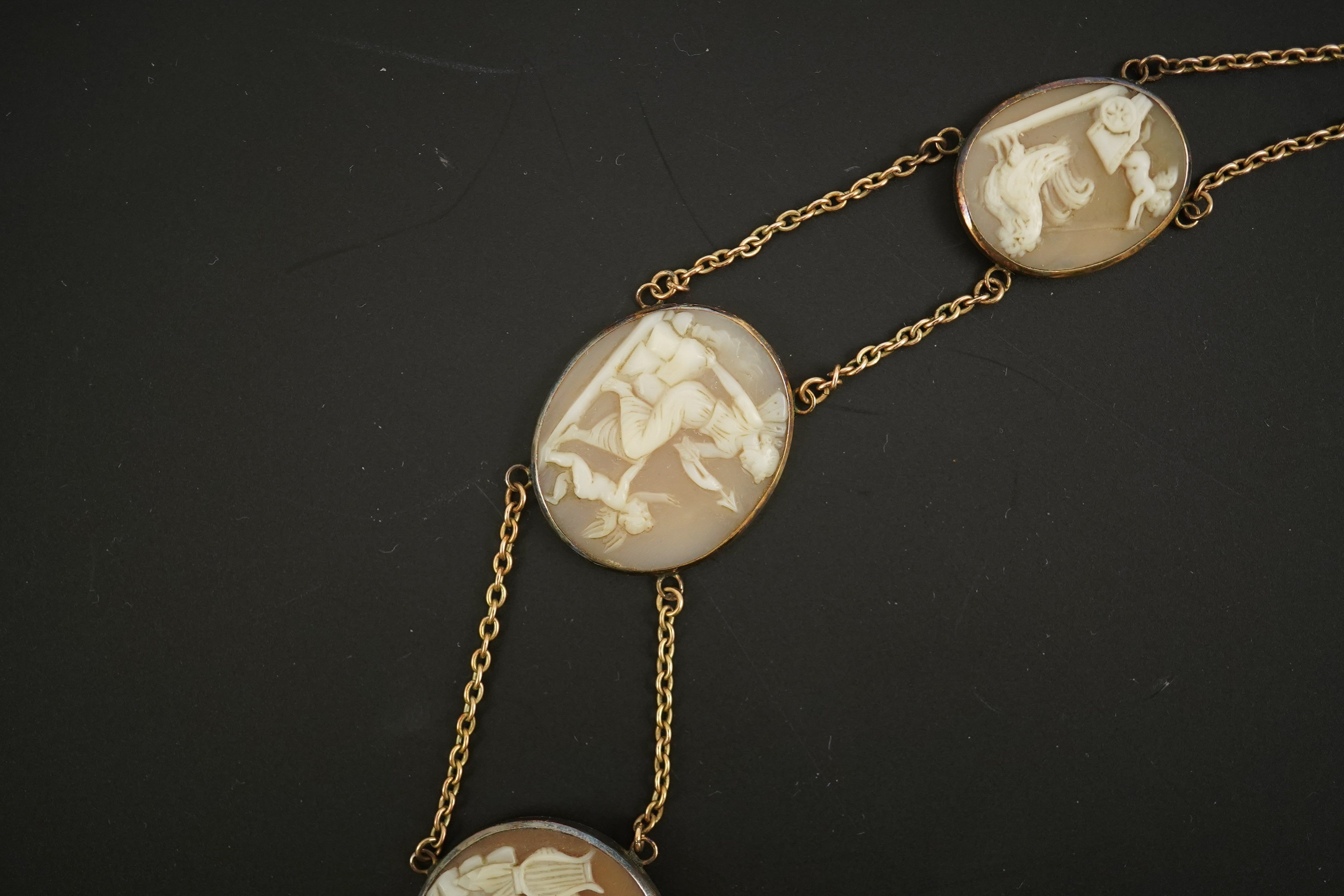 An early 19th century Italian Grand Tour gold double chain link and ten graduated oval cameo shell set necklace